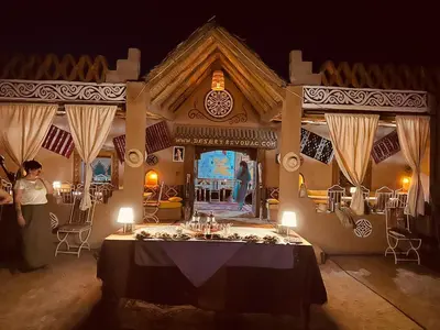 a dining room with a table in the middle of it at Desert Chegaga Luxury Camp in El Gouera