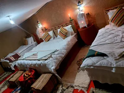 two large beds in a room with at Desert Chegaga Luxury Camp in El Gouera