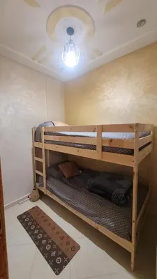 two bunk beds in a room with a ceiling at Charme & Confort au Cœur de Meknes in Meknès