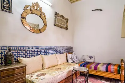 a living room with a couch and a mirror at Dar Fatimazahra in Fès