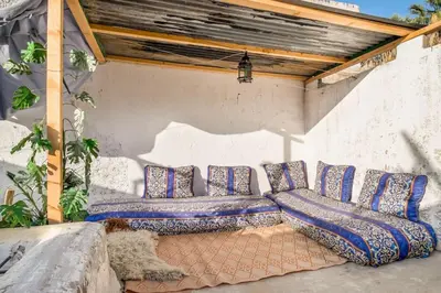 a dog laying on the ground under a pergola at Dar Fatimazahra in Fès