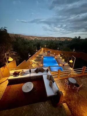 an overhead view of a swimming pool with tables and chairs at Riad Sahara Stars Dades in Boumalne