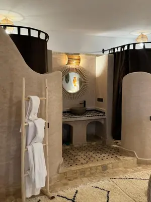 a bathroom with a sink and a mirror at Riad Sahara Stars Dades in Boumalne