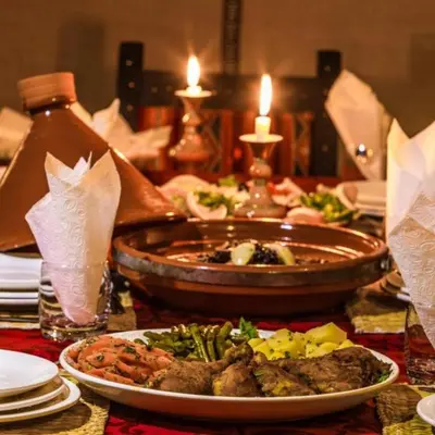 a table with plates of food on a table at Camel Experience Camp in Merzouga