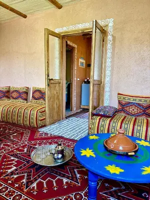a living room with a couch and a table at Villa Mouloud, Authentic Amazigh Family Villa, Fireplace & Garden in Khenifra