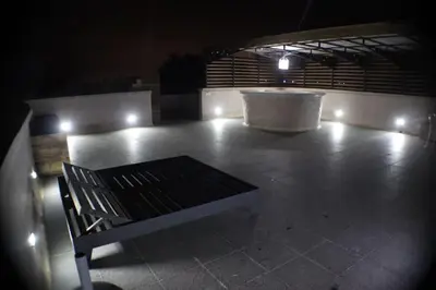 a bench sitting on a tiled floor with a fountain at Villa privée dans un environnement idyllique in Marrakech