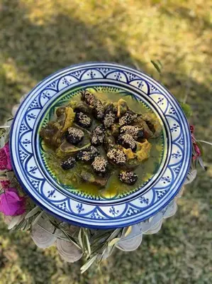 a blue and white plate of food on a table at Villa privée dans un environnement idyllique in Marrakech