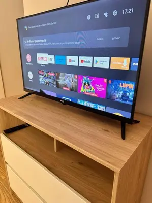 a flat screen tv sitting on top of a wooden stand at Family confort Fes in Fès