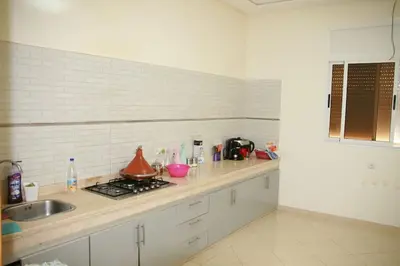 a kitchen with a sink and a counter top at Maison Dar Zarka in Aghmat