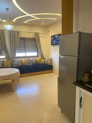 a living room with a refrigerator and a couch at مولاي يعقوب in Fès