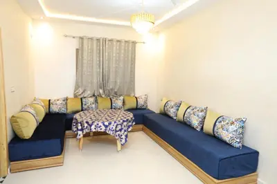 a living room with a blue couch and a chair at مولاي يعقوب in Fès