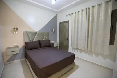 a bedroom with a bed and a large window at مولاي يعقوب in Fès