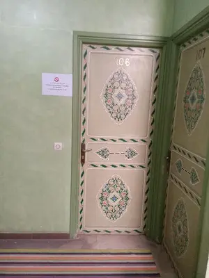 a room with two doors with patterns on them at Hotel Des voyageur in Ouarzazate