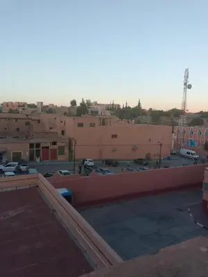 a view of a parking lot with buildings at Hotel Des voyageur in Ouarzazate