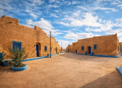 a row of brick buildings in a desert setting at chez aubazine in Merzouga