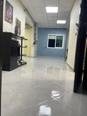 a large room with a tile floor in a building at Cozy Downtown Apartment in Fès