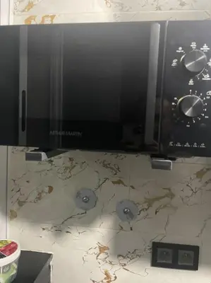 a microwave sitting on top of a counter at Cozy Downtown Apartment in Fès