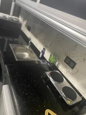 a bathroom counter with a sink and a toothbrush at Cozy Downtown Apartment in Fès