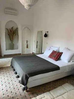 a bedroom with a large bed in a room at Villa-Riad Nejma in Marrakech