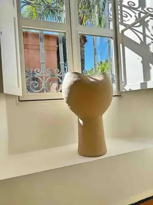 a vase sitting on a window sill next to a window at Villa-Riad Nejma in Marrakech
