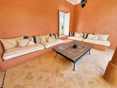a living room with two couches and a coffee table at Villa-Riad Nejma in Marrakech