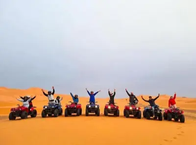 a group of people on atvs in the desert at Merzouga Luxurious Camp in Merzouga