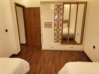a room with two beds and a mirror at زاوية سيدي عبد السلام افران in Ifrane