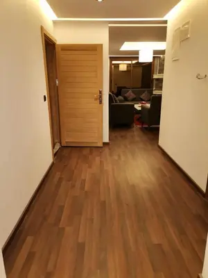 an empty living room with a hard wood floor at زاوية سيدي عبد السلام افران in Ifrane