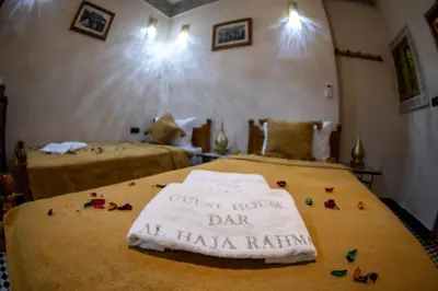 a room with two beds with a sign that reads guest house day at halo at Dar Elhaja Rahma in Fès