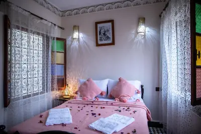 a bedroom with a pink bed and a window at Dar Elhaja Rahma in Fès