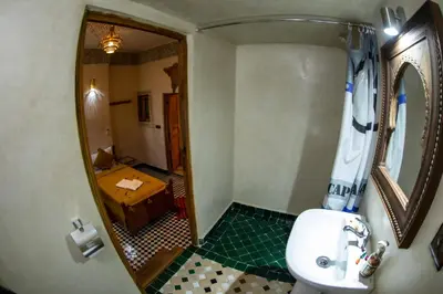 a bathroom with a sink and a mirror at Dar Elhaja Rahma in Fès