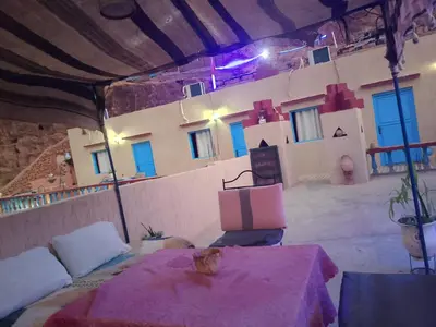 a room with a table and chairs and a building at Auberge ALI Todra A Natural Oasis in Tinerhir