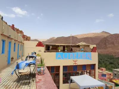 a building with a sign on the side of it at Auberge ALI Todra A Natural Oasis in Tinerhir