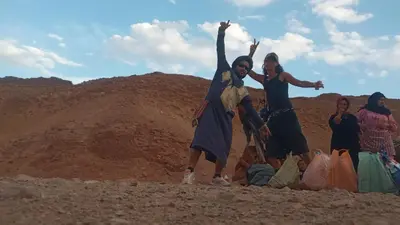a group of people standing in the desert at Auberge ALI Todra A Natural Oasis in Tinerhir