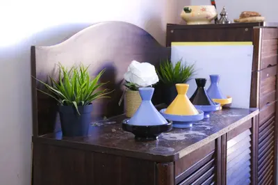a shelf with different colored vases and plants on it at Elhachimi two bedroom with air conditioning in Er Rachidia