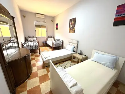 a living room with two beds and a couch at Elhachimi two bedroom with air conditioning in Er Rachidia