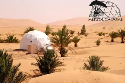 a tent in the middle of a desert at Merzouga Dome in Merzouga