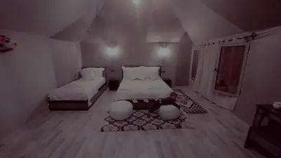 a small room with two beds and a rug at Hamada Activities Luxury Camp in Merzouga