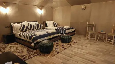 a bedroom with two beds in a room at Hamada Activities Luxury Camp in Merzouga