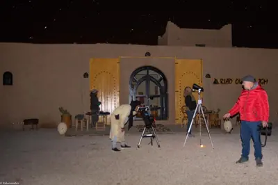 a group of people with cameras in front of a building at Riad Ouzina TGM in Ouzina