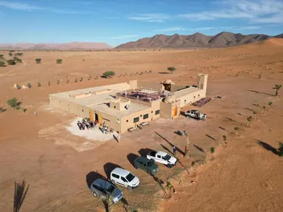 an aerial view of a building in the desert at Riad Ouzina TGM in Ouzina