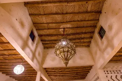 a chandelier hanging from the ceiling of a building at Riad Ouzina TGM in Ouzina