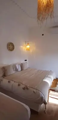a white bedroom with a large bed in a room at Zagora Oasis Lodge & Desert Excursions in Zagora