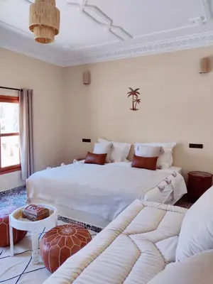 a bedroom with two beds and a couch at Zagora Oasis Lodge & Desert Excursions in Zagora