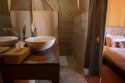 a bathroom with a bowl sink and a bed at Erg chegaga Daya Luxury Camp - Sahara Desert Stay in Mhamid