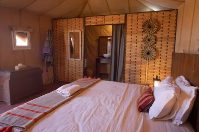 a bedroom with a bed with towels on it at Erg chegaga Daya Luxury Camp - Sahara Desert Stay in Mhamid