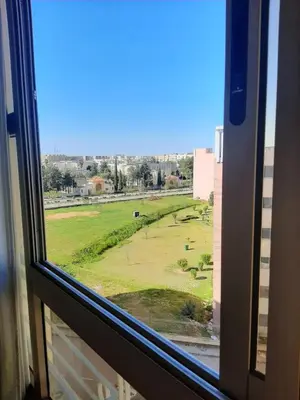 a view of a large field from a window at Charmant appartement à louer à meknès in Meknès