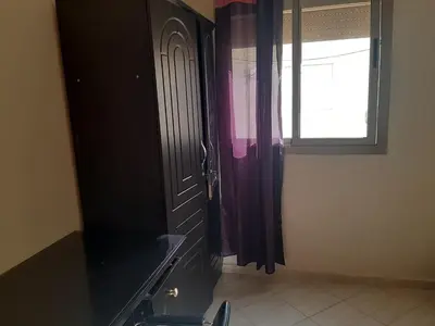 a room with a door and a window and a window at Charmant appartement à louer à meknès in Meknès