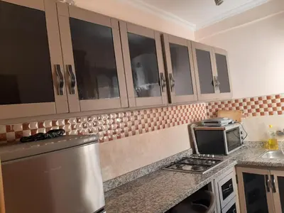 a kitchen with a refrigerator and a microwave at Charmant appartement à louer à meknès in Meknès