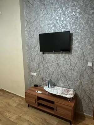 a living room with a tv on a wall at Apprt in Fès
